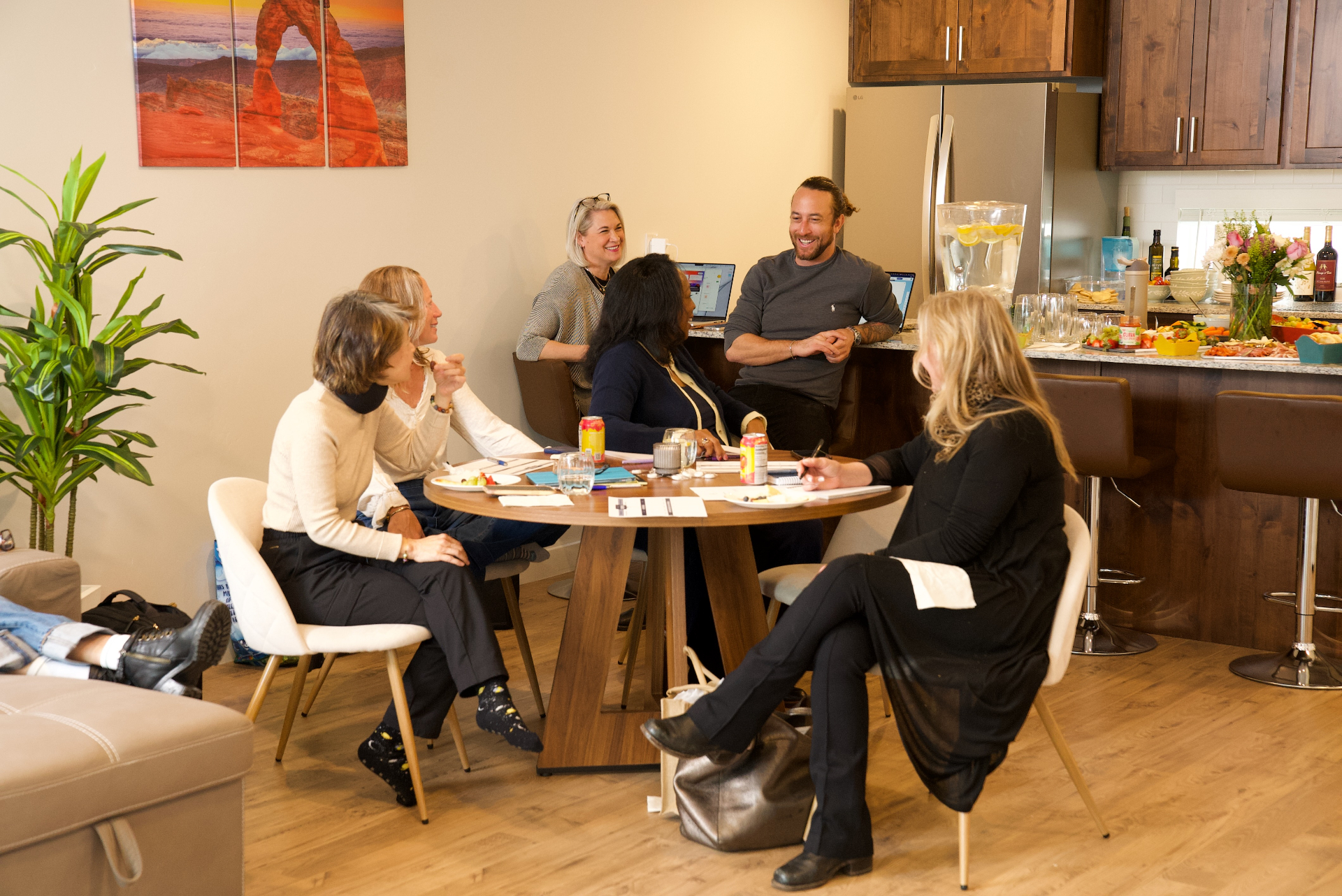 Ricky leading a small-group AI working session around a kitchen table